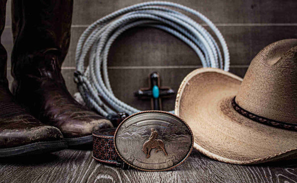 cowboy hat, belt buckle, and western shoes