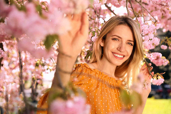 Women standing under a cherry blossom tree